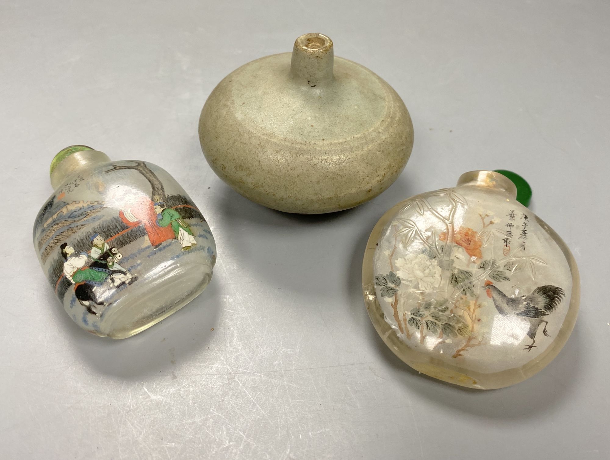 A Chinese inside painted rock crystal snuff bottle and inside painted glass snuff bottle and a small Chinese celadon jarlet, tallest 8c